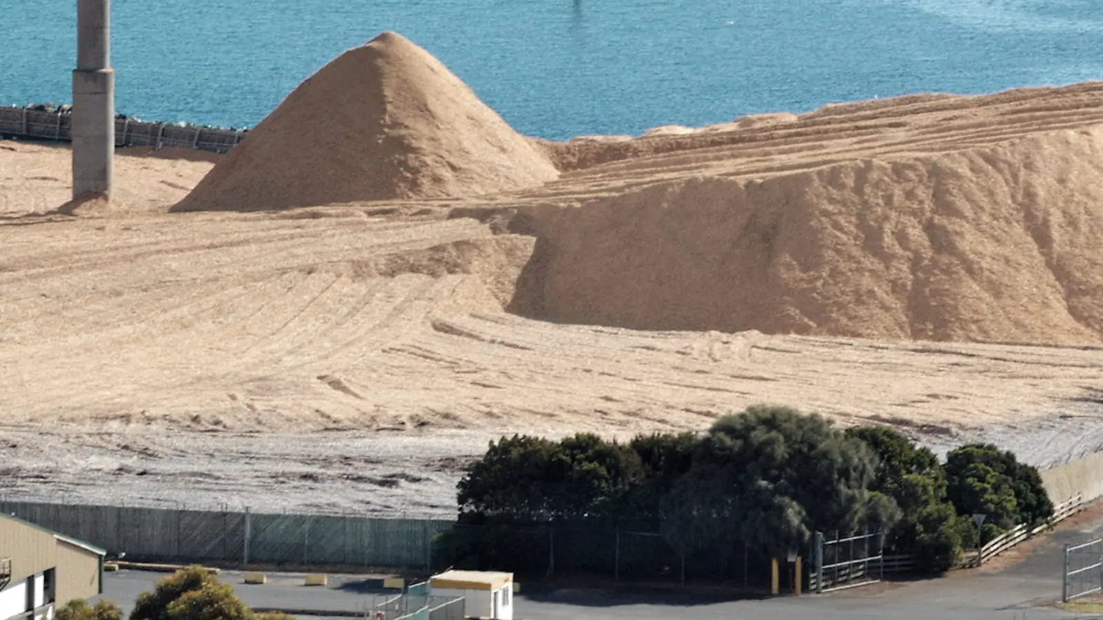 Woodchip stockpiles at a bulk terminal for pulp and paper trade